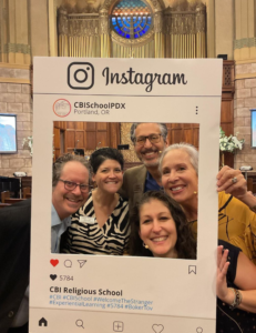 The CBI clergy and Education director pose in the Main Sanctuary with an Instagram frame.